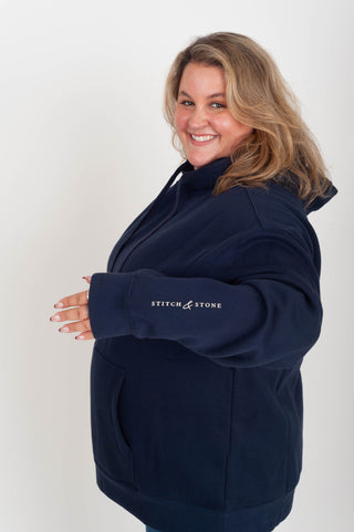 women wearing a navy hoodie with "Babes Supporting Babes" on the back