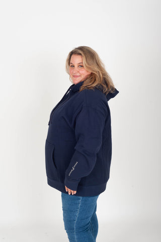 women wearing a navy hoodie with "Babes Supporting Babes" on the back