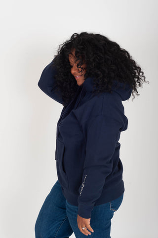 women wearing a navy hoodie with "Babes Supporting Babes" on the back