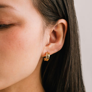 a women wearing gold hoop earrings