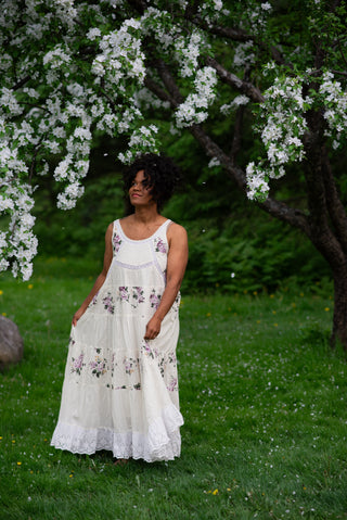 Women wearing a white dress in front a cherry blossom tree