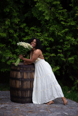 Women in a Boho Maxi dress holding a bouquet of flowers