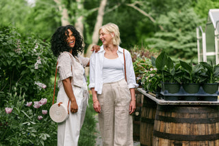 two women in a flower cardigan wearing opposite linen sets.