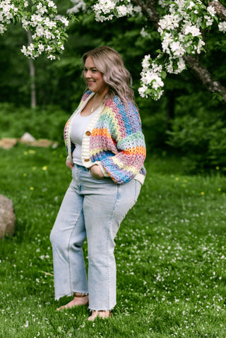 Women wearing a bright cardigan in a garden.