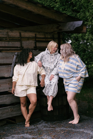 Women wearing lounge sets in a garden. 