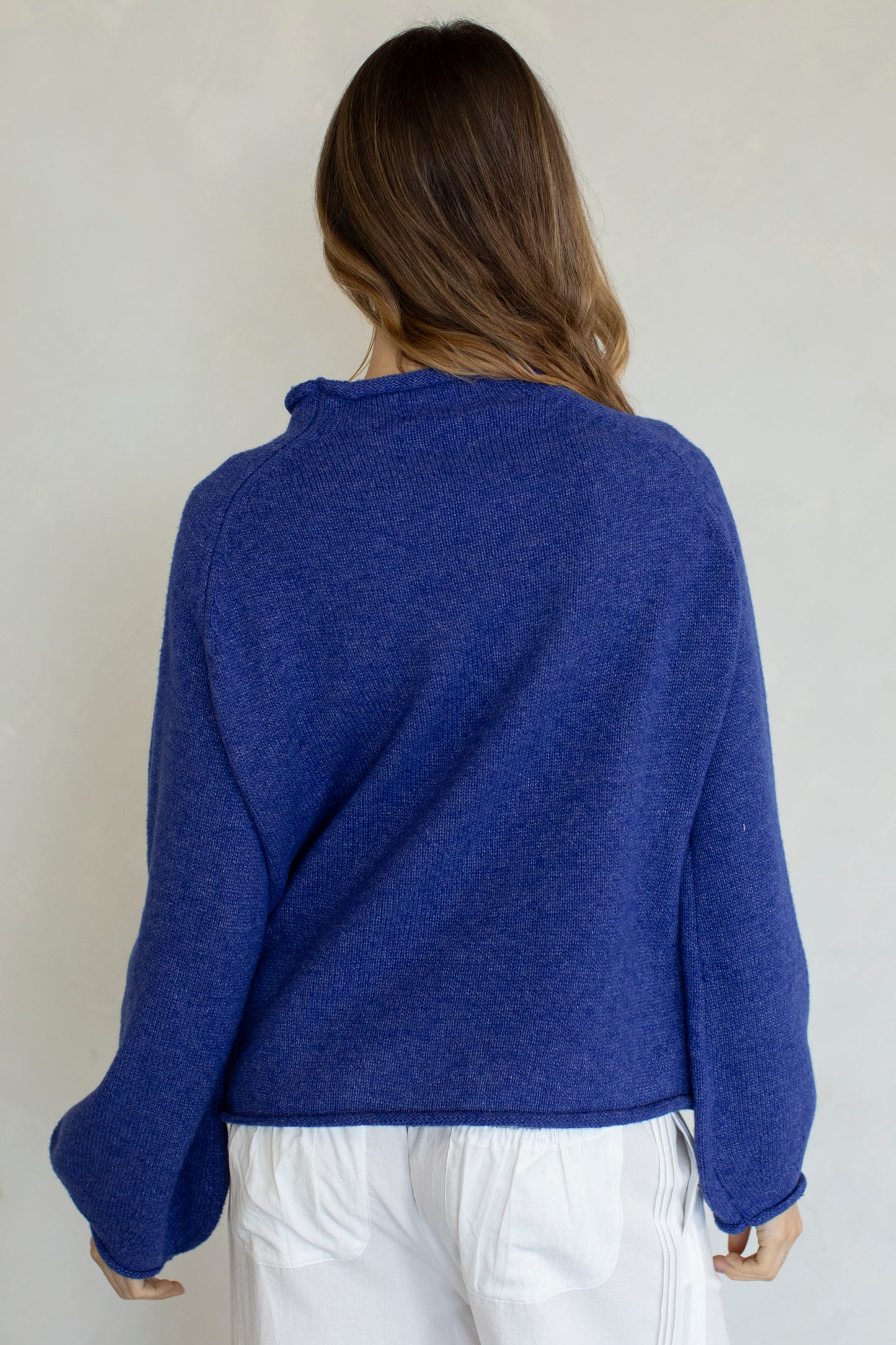 women wearing a royal blue sweater with a duck print on it.