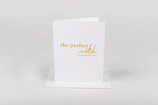White card with gold text 'the perfect match' on a white background