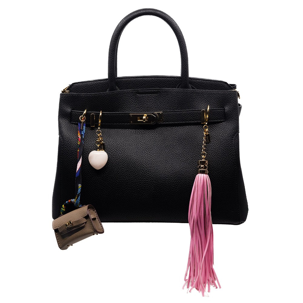 Black handbag with decorative tassel and charm on a white background