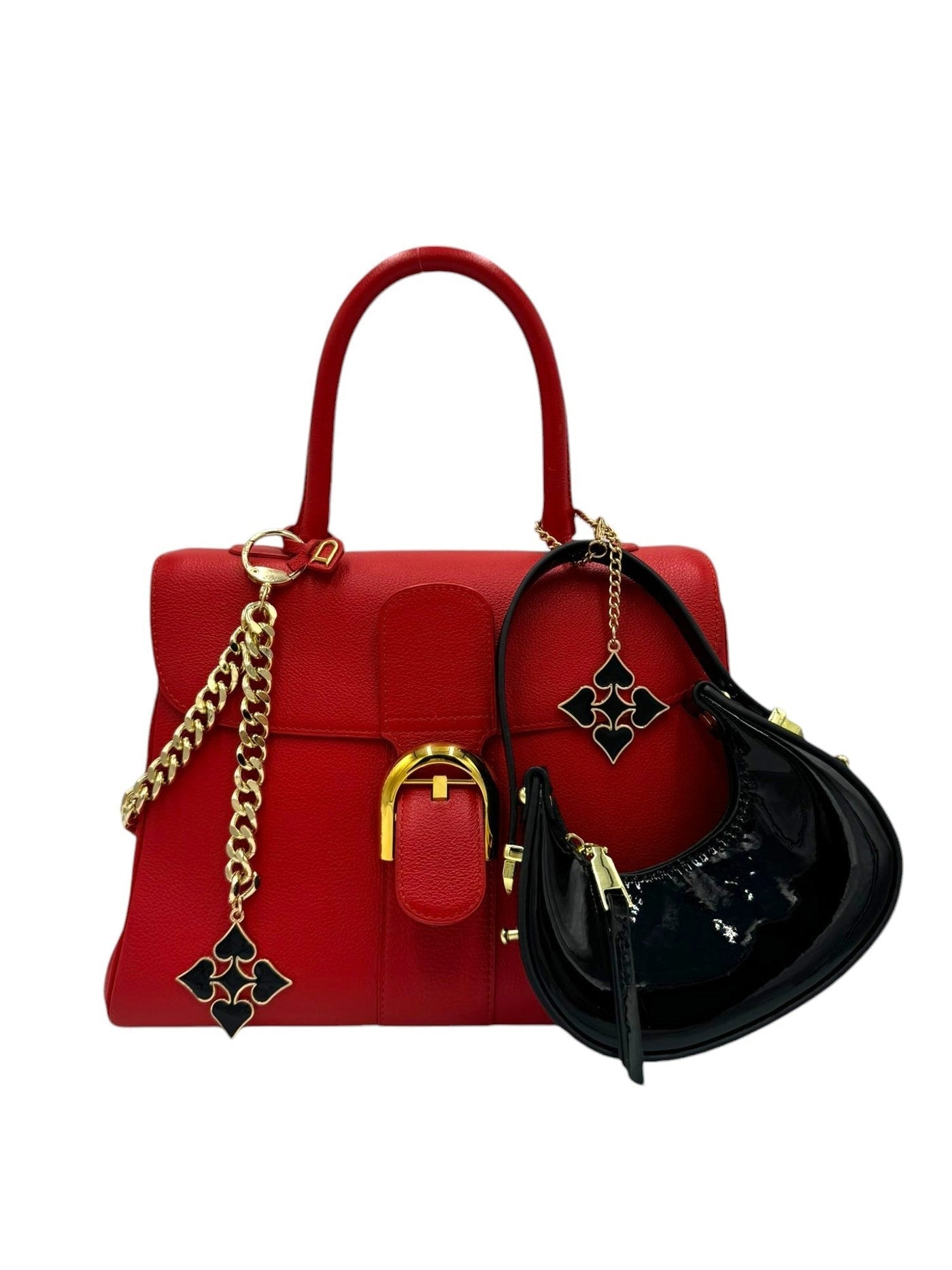 Red handbag with gold chain and black pouch on a white background