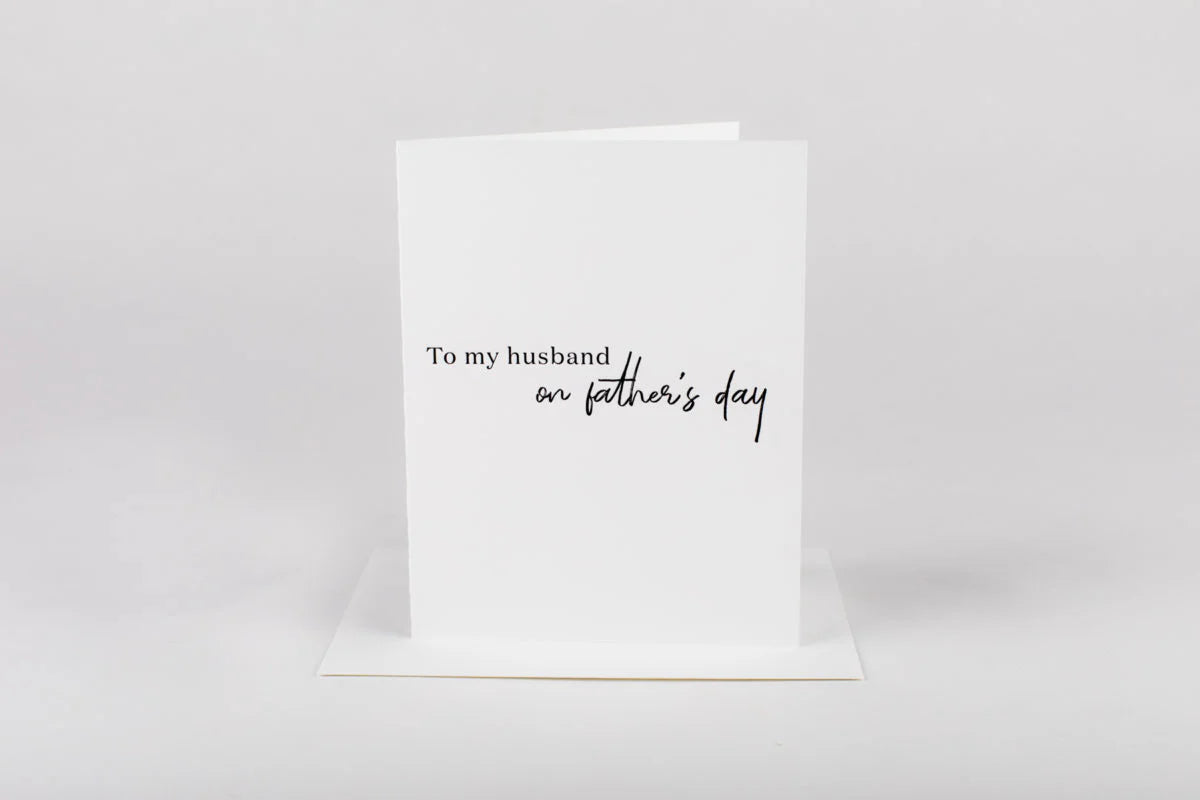 Greeting card with 'To my husband on father's day' text on a white background
