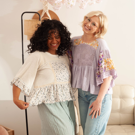 two women wearing flowy floral boho tops