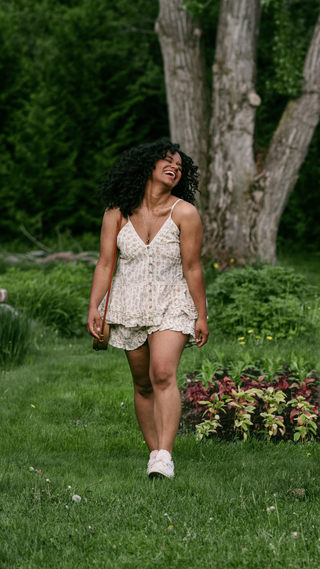 A women wearing a matching outfits walking in a garden.