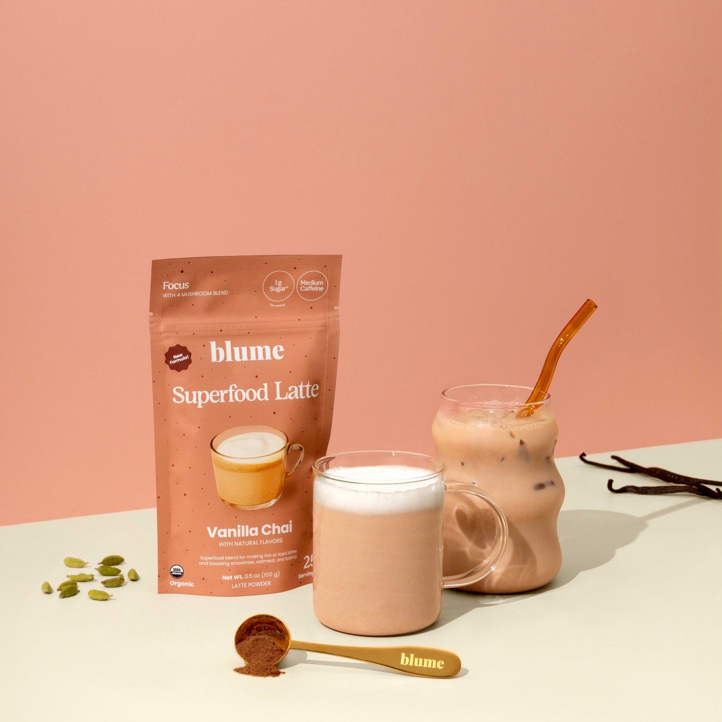 Blume Superfood Latte Vanilla Chai package with two glasses of the latte on a pink background