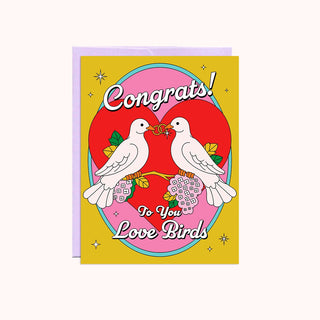 Greeting card with two birds, a heart, and 'Congrats! To You Love Birds' text on a yellow background.