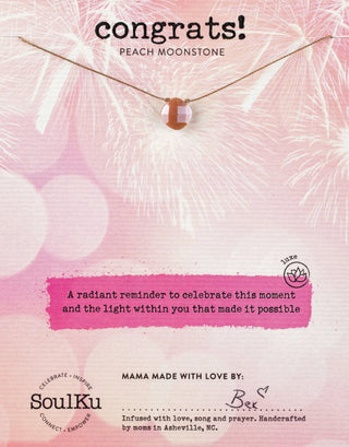 Necklace with peach moonstone on a pink background with 'SoulKu' branding.