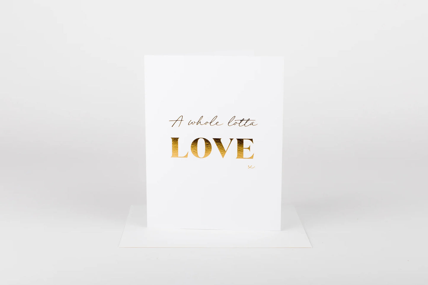 White card with gold text 'A whole lotta LOVE' on a white background