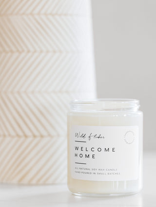 welcome home candle on a table