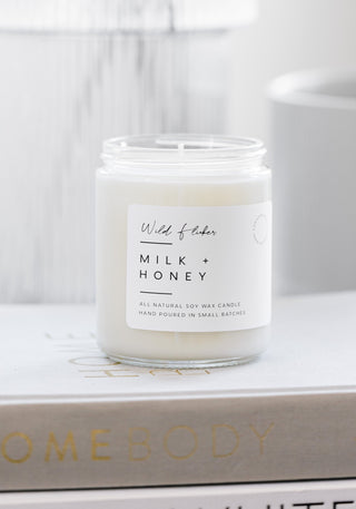 milk & honey candle on books