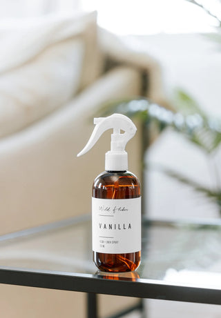 Vanilla-scented spray bottle on a table with a blurred background