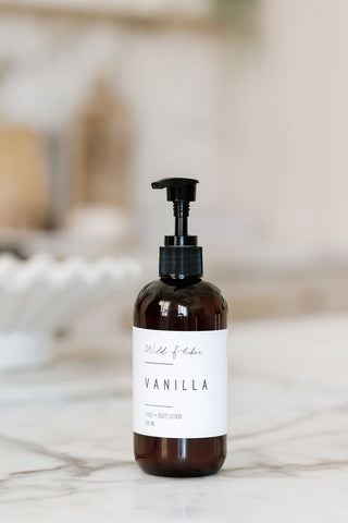 Brown bottle with pump and vanilla label on a marble surface