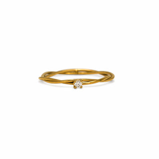 Gold ring with a diamond on a white background