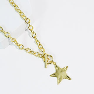 A Gold Star pendant chain link necklace on a white background. 