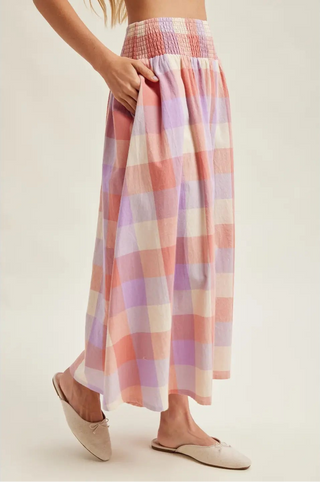 Pastel plaid skirt worn by a person on a plain background
