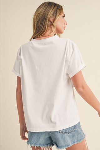 Woman wearing a white t-shirt and denim shorts on a beige background