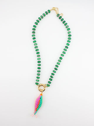 Green beaded necklace with a colorful pendant on a white background
