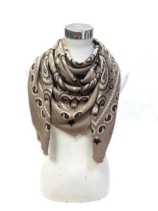 A beige and brown paisley bandana scarf draped on a white mannequin torso against a white background.