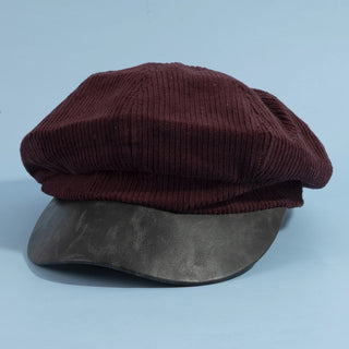 Two caps, one brown and one black, on a light blue background