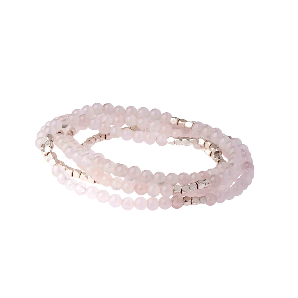 Set of pink beaded bracelets on a white background