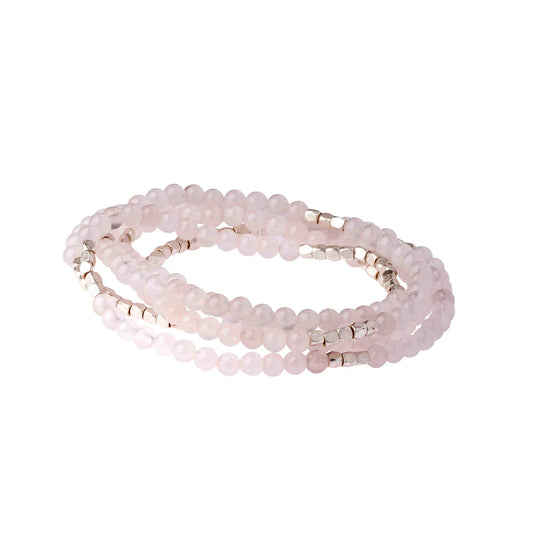 Set of pink beaded bracelets on a white background