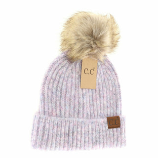 Knitted beanie with fur pom-pom and brand tag on a white background
