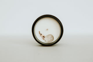 top view of candle with a crystal in it. 
