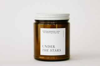 Candle jar with a label on a white background