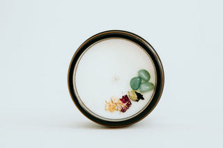 a top view of a candle with crystals in it.