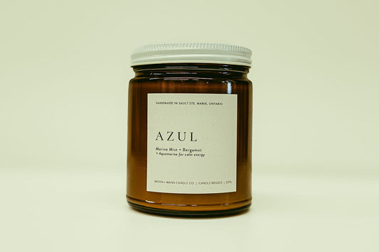 Candle jar labeled 'AZUL' on a beige background