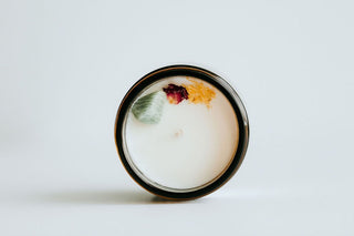 a top view candle with a crystal in it. 