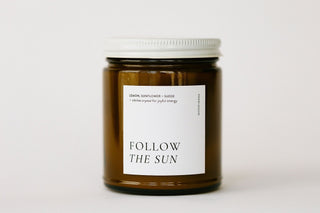 Candle jar labeled 'Follow the Sun' on a white background