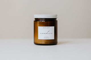 Candle jar with a white label on a light background