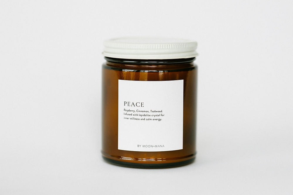 Candle jar labeled 'Peace' on a white background