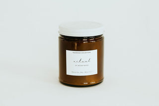 Jar of candle with a label on a white background