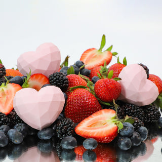 three lip balms sitting on berries