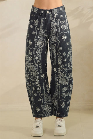Navy blue pants with white pattern worn by a person on a beige background