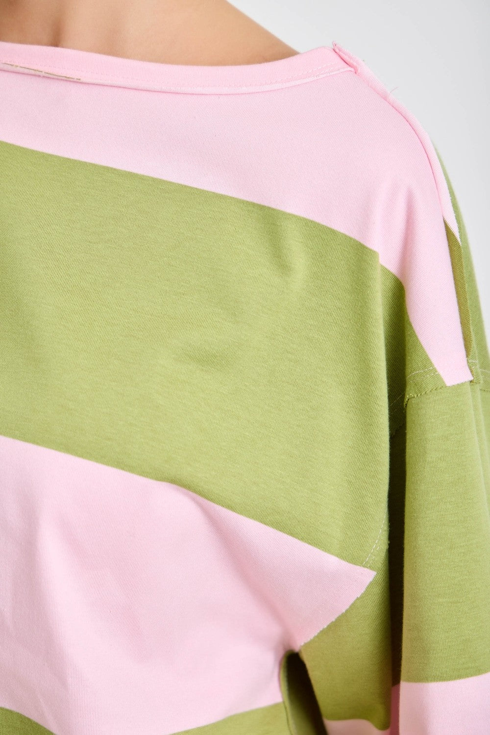 Color-blocked top with pink and green sections on a plain background