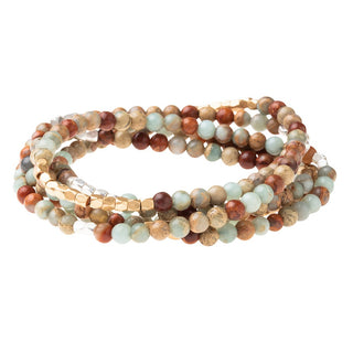 a beaded crystal wrap bracelet of necklace on a white background