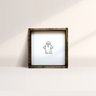 A square wooden frame with a white background featuring a silkscreened ghost design in the center.