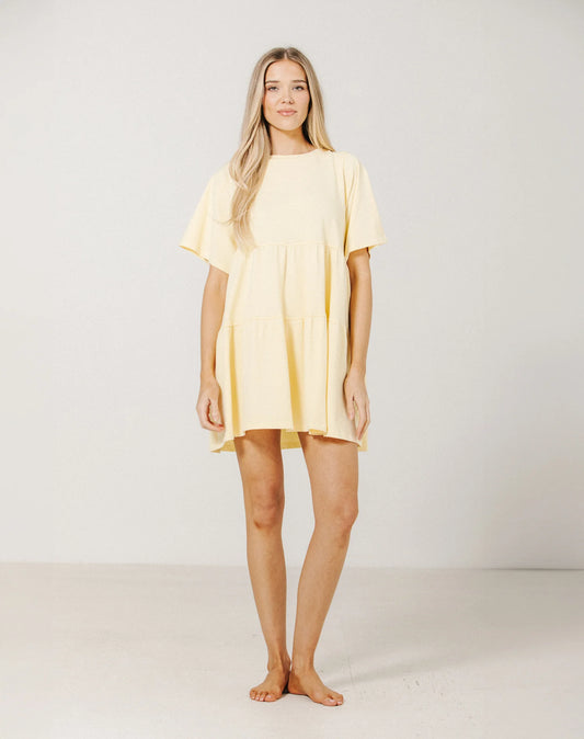 Woman wearing a yellow dress against a white background