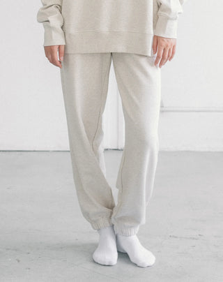 Women wearing an oversized jogger against a neutral photo backdrop. 